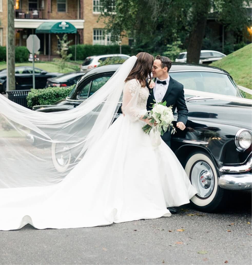 Сouple wearing a white gown and a black suit