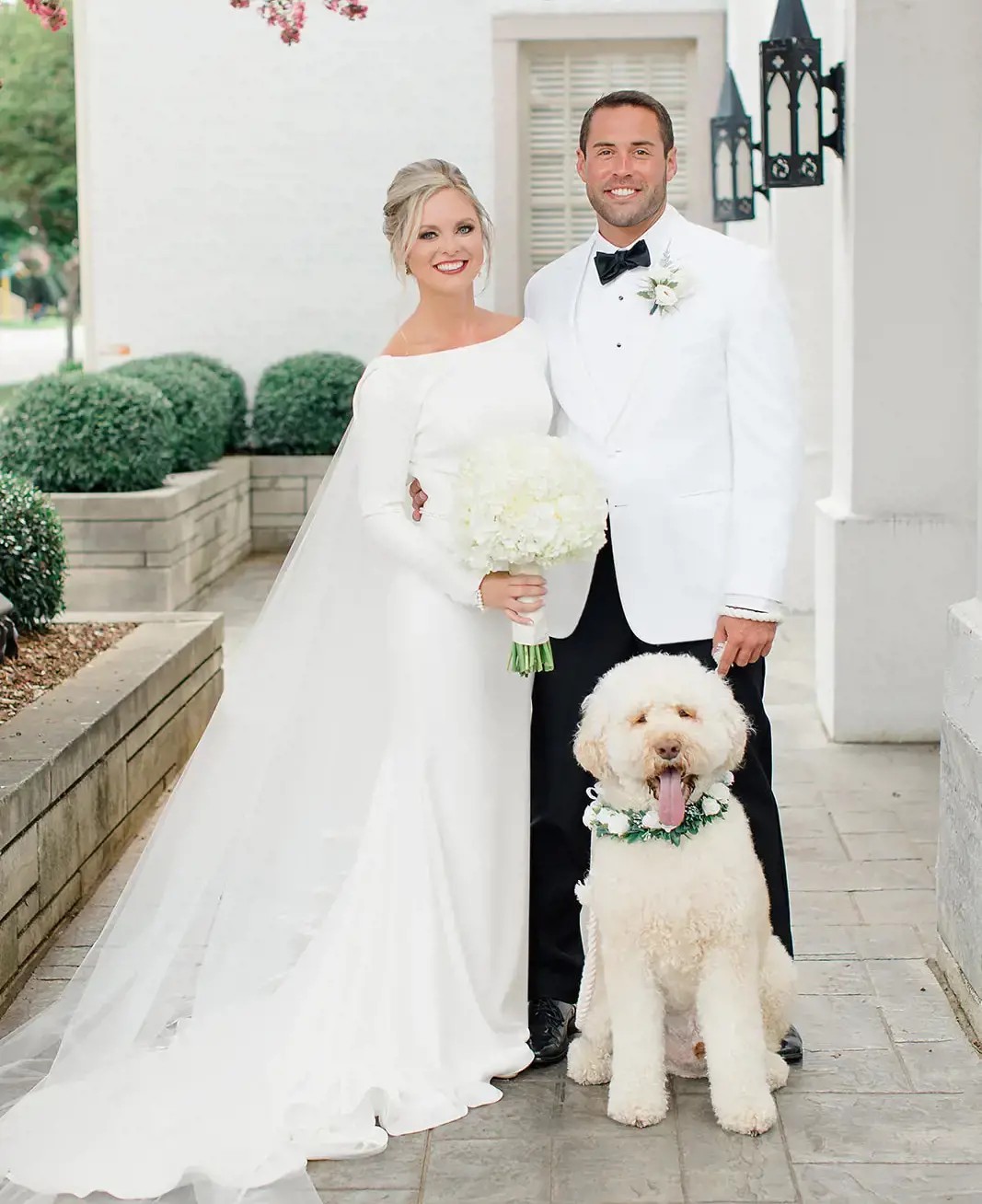 Сouple wearing a white gown and a black suit