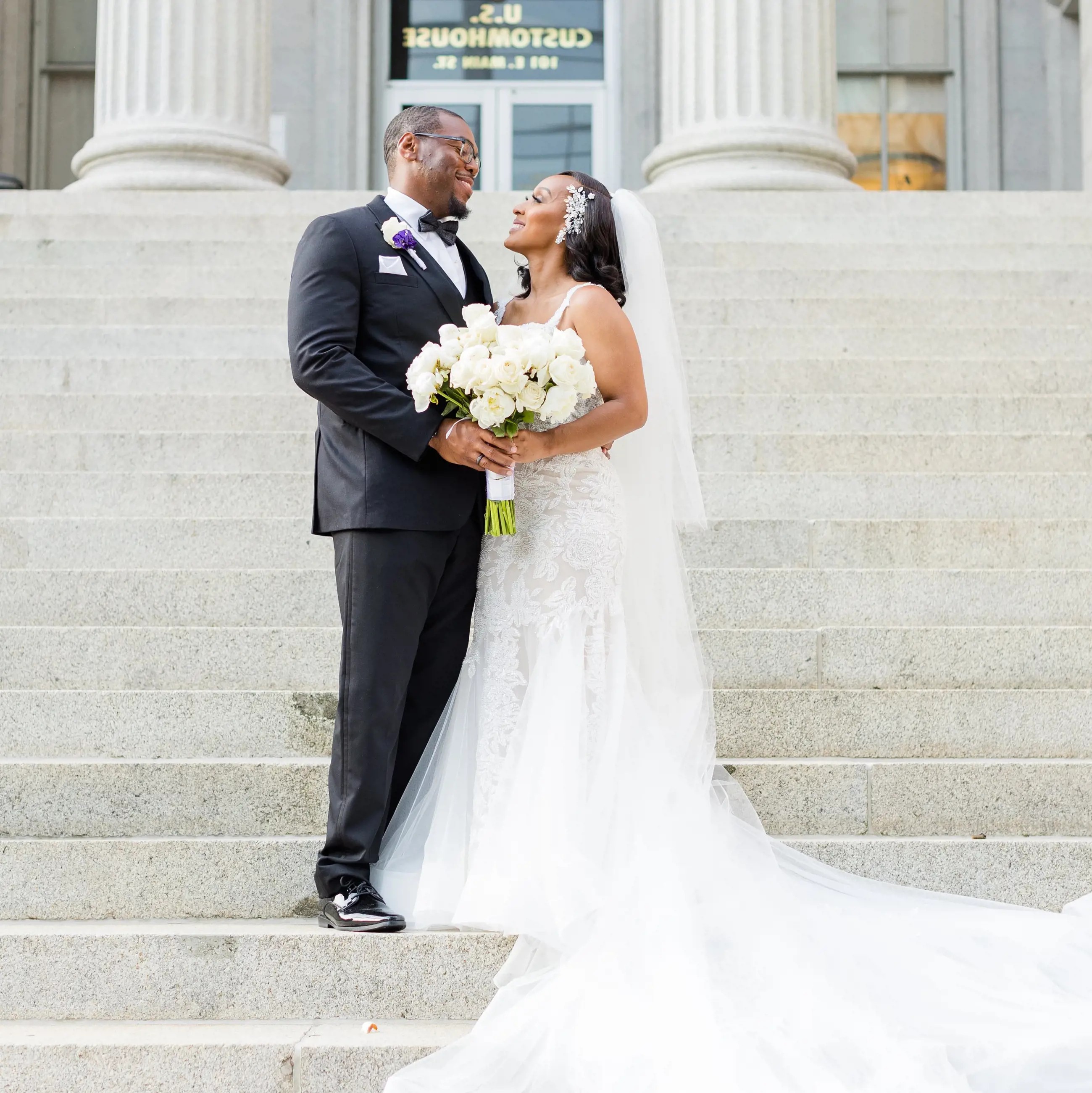 Сouple wearing a white gown and a black suit